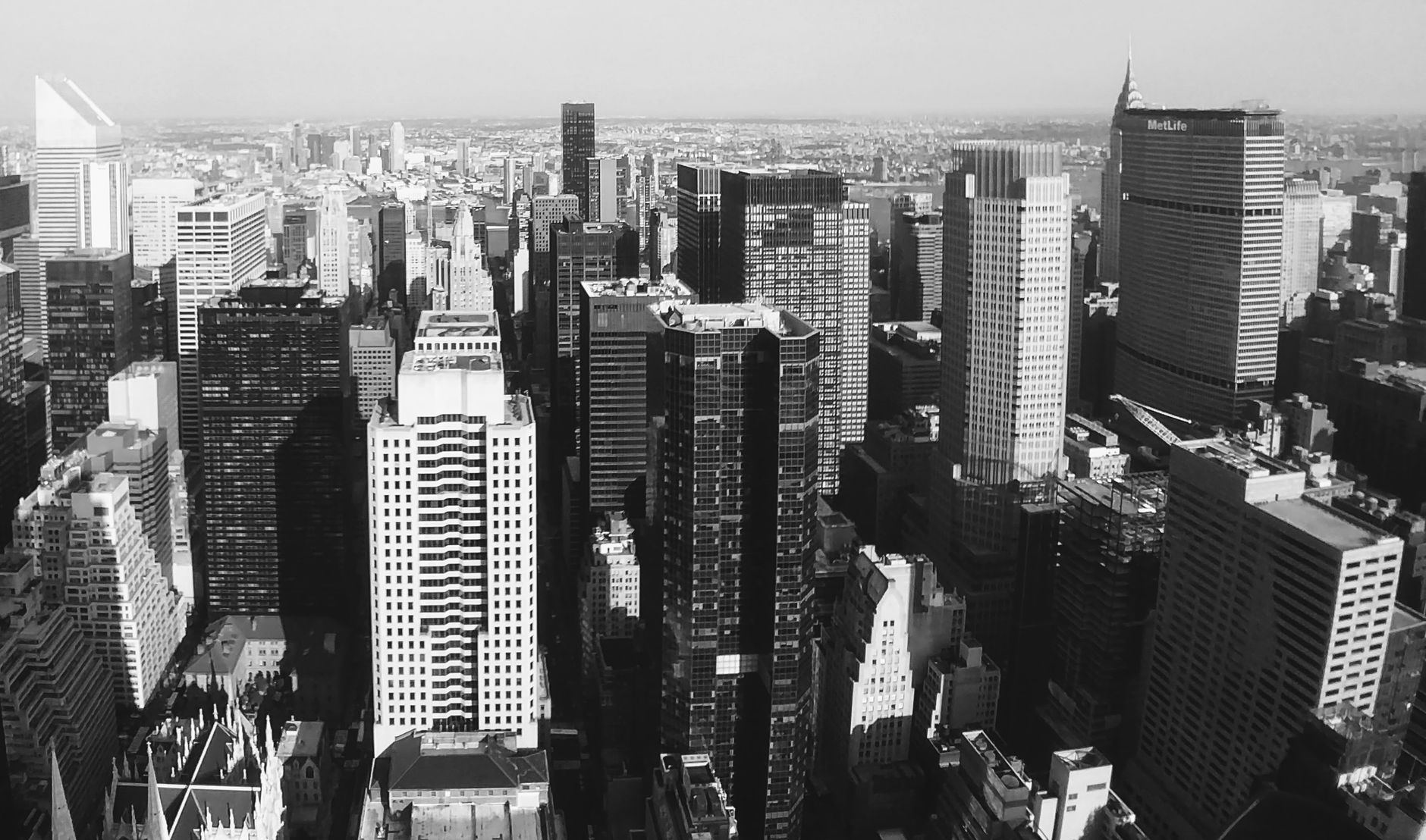A striking black and white aerial cityscape of New York City featuring iconic skyscrapers.