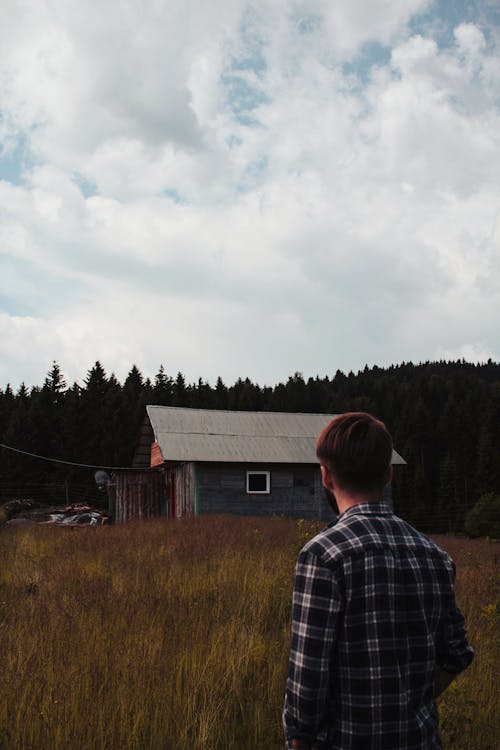 A Man Standing on the Grass Field