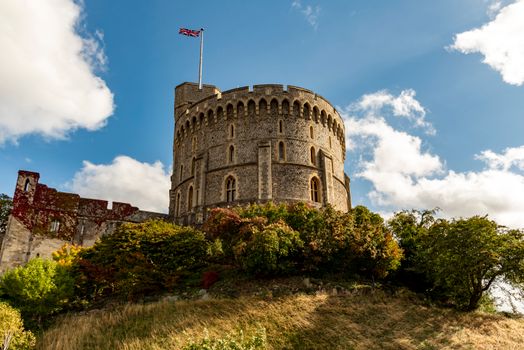 Stunning view of Windsor Castle, England, with lush surroundings and vivid blue skies.