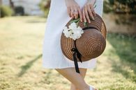 Woman in White Dress Holding Brown Woven Basket