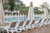 White Plastic Chairs on Poolside