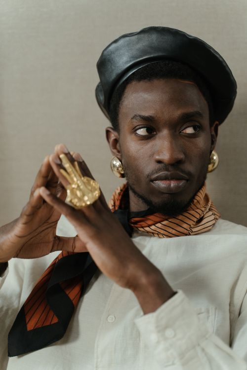 Free Elegant young man in a black hat, showcasing fashion with striking accessories. Stock Photo
