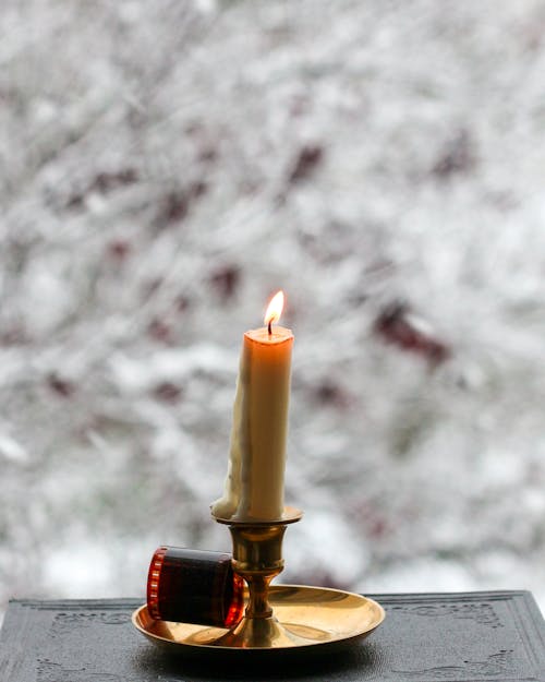 Lighted Candle on Brass Candle Holder
