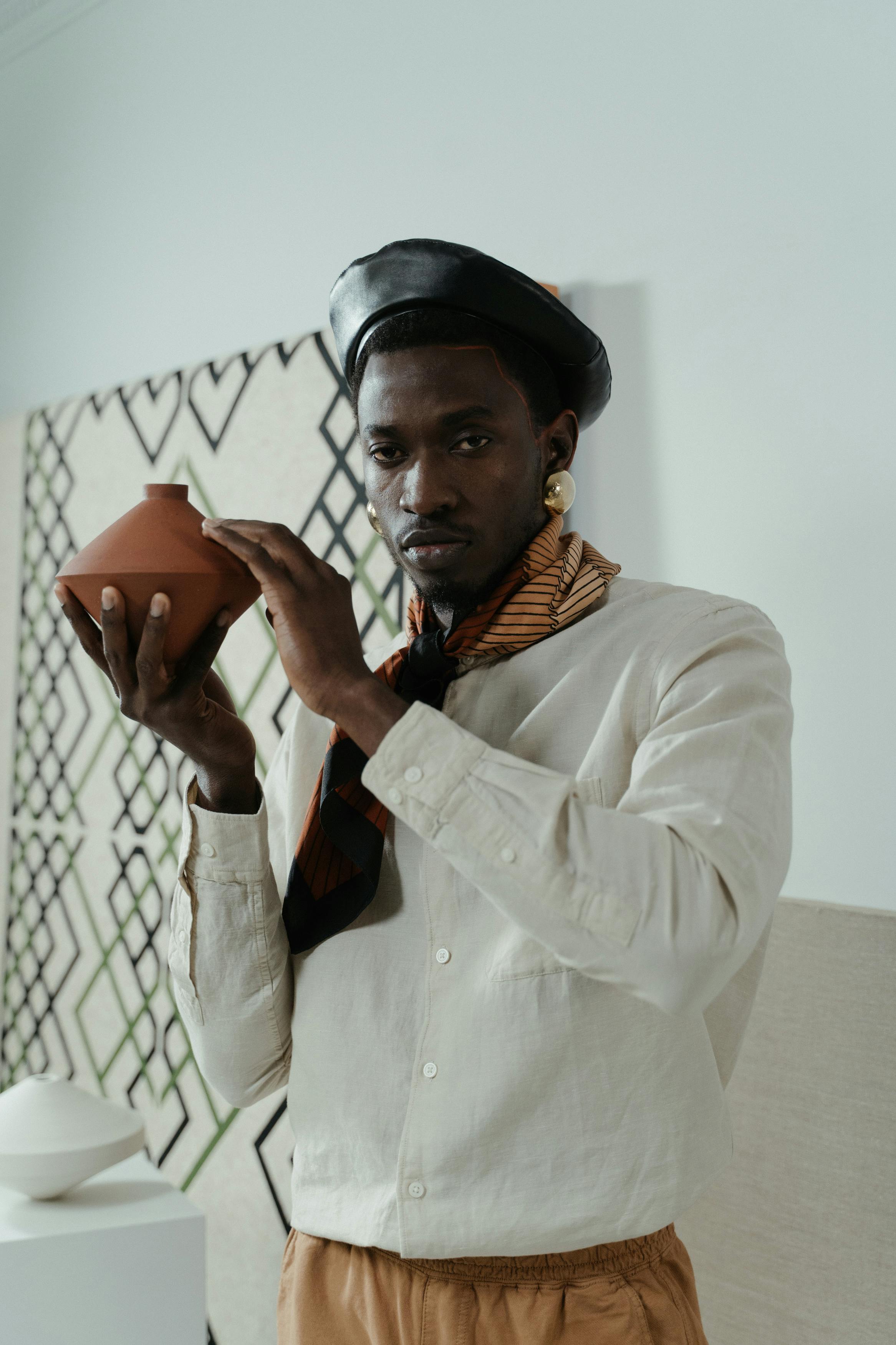 a man holding a clay pot