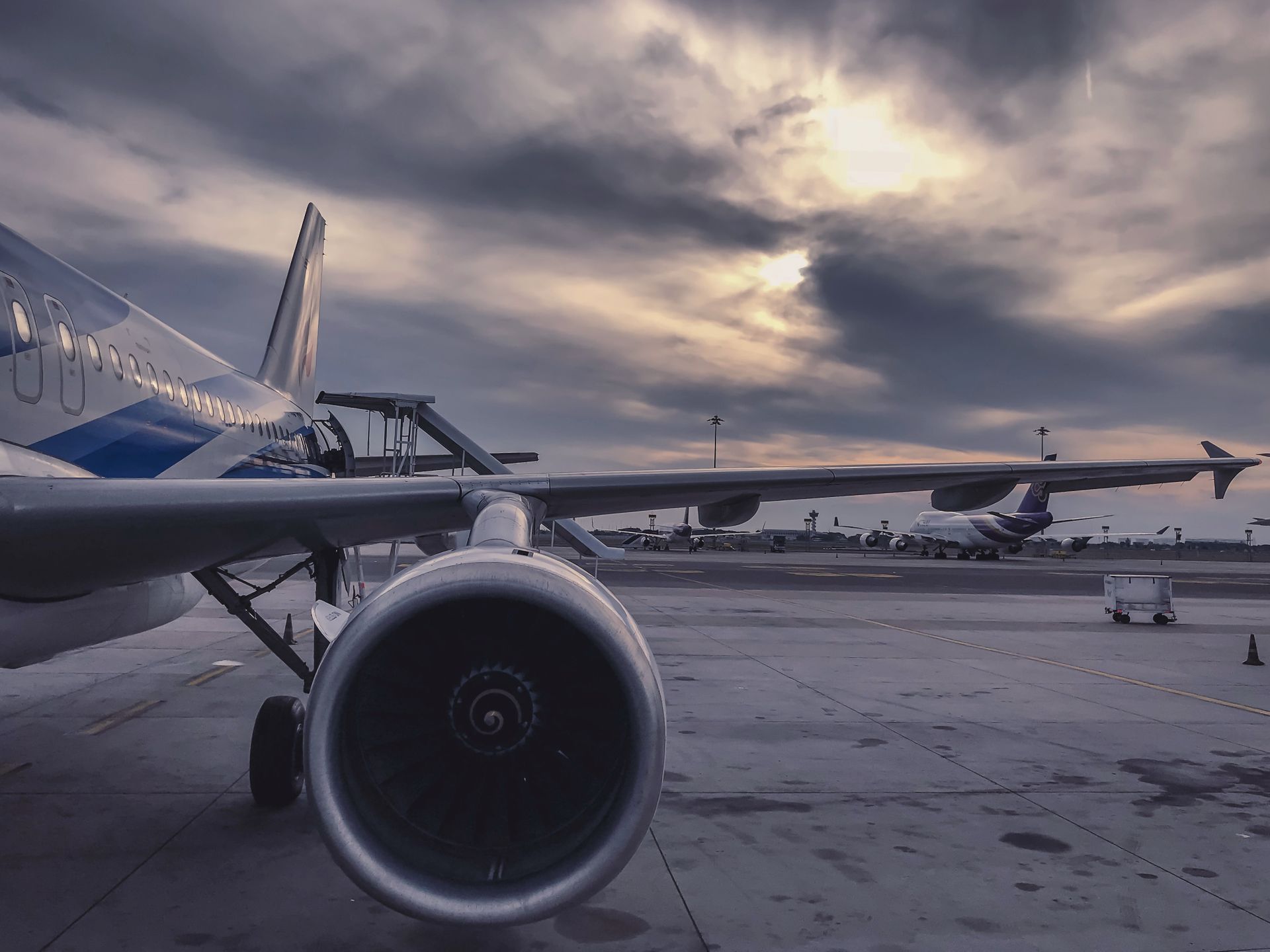 Airplane flying over tropical coastline at sunset — flights to Puerto Escondido