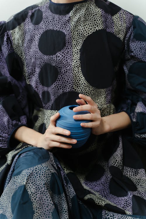 A Person Holding a Blue Vase
