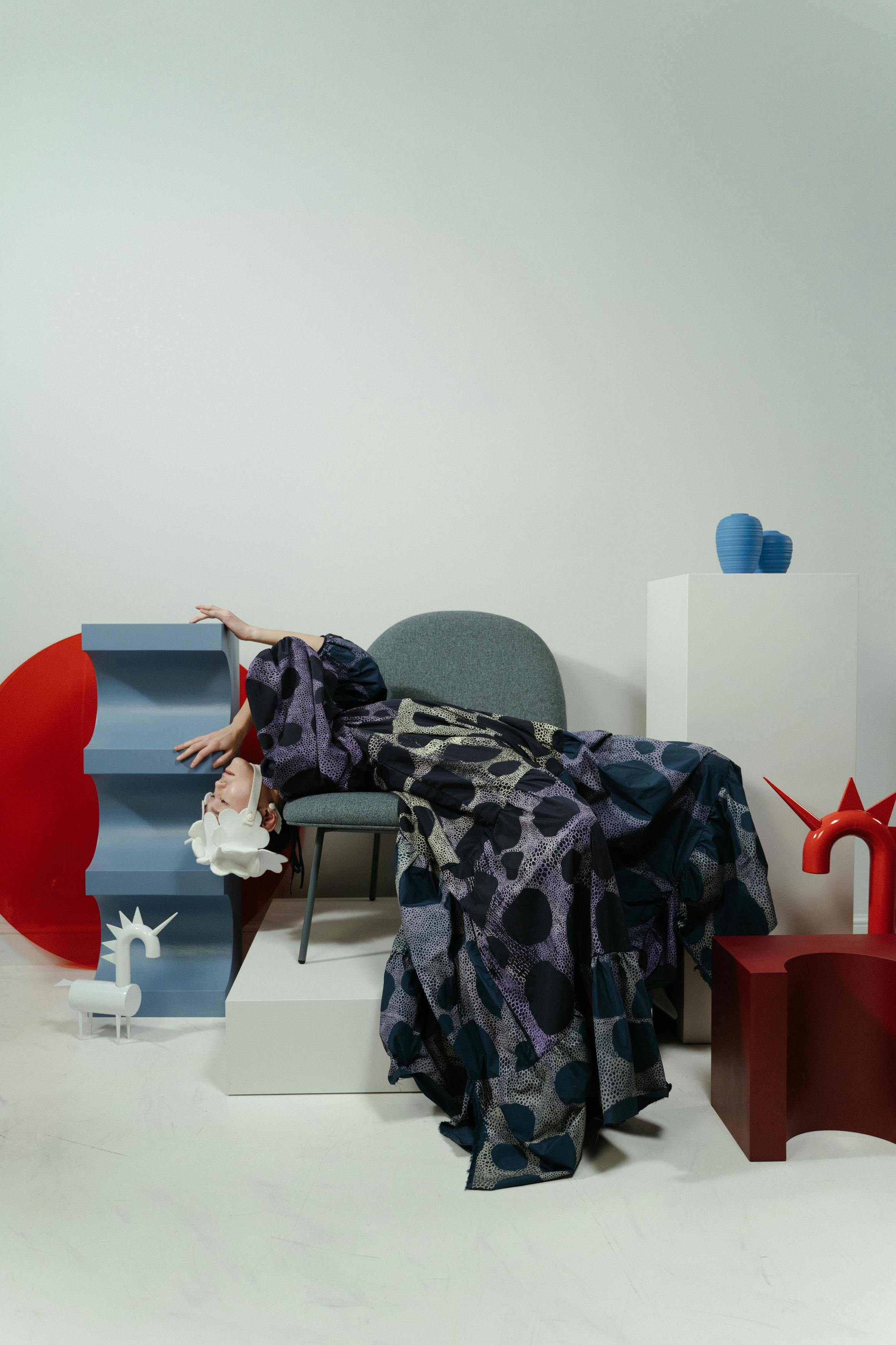 a woman with white headwear lying on chair