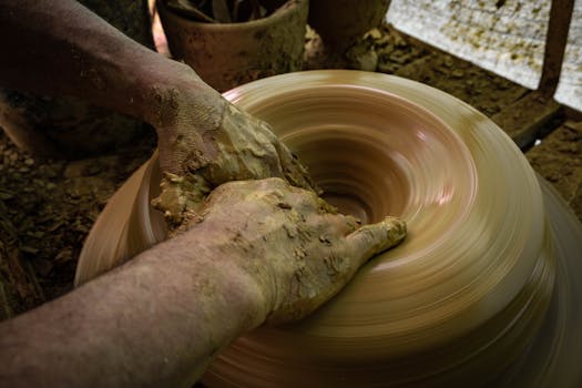 Close-up of hands shaping clay on a spinning wheel in Ráquira, Colombia.