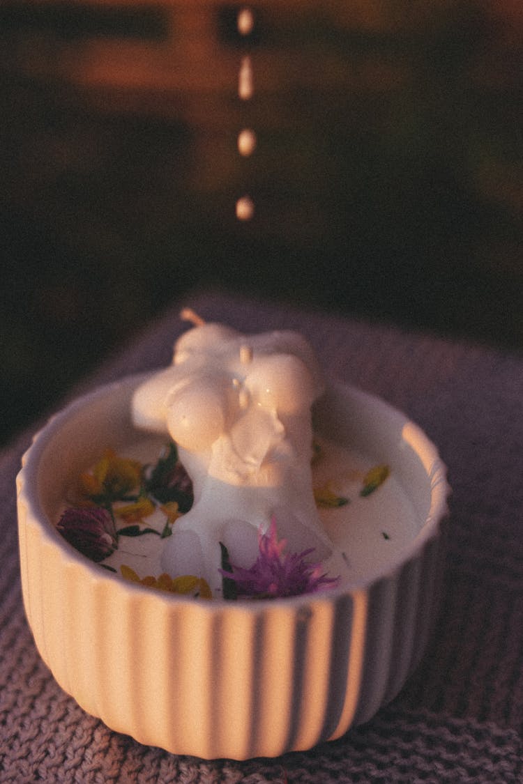 Droplets Of Milk Splashing In Bowl With Petals