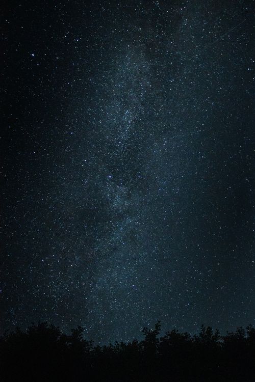 Free Capture of a vivid and starry night sky over rural Poland, showcasing the Milky Way and numerous stars. Stock Photo
