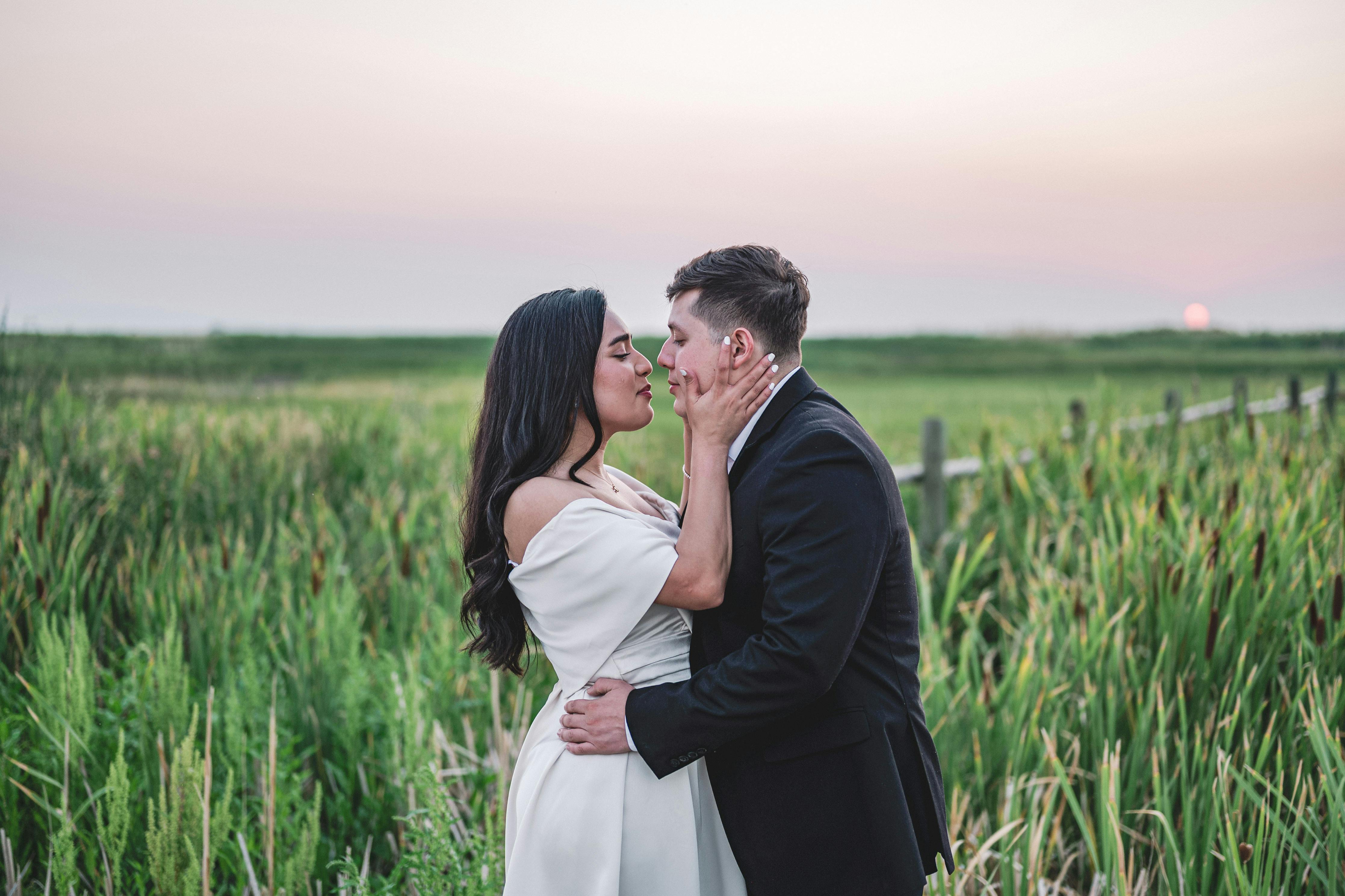 A happy, romantic couple sharing a joyful and intimate moment together outdoors during the golden hour, capturing the feeling of reconnection and falling in love again.