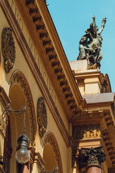 Low angle view of baroque architecture and sculptures in daylight.