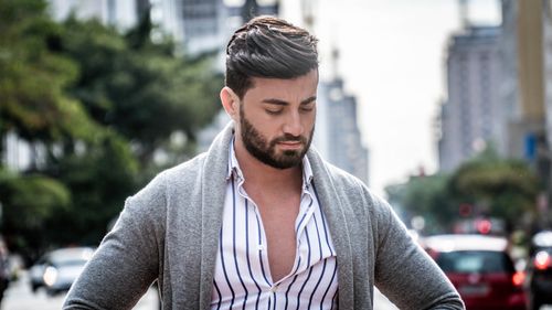 Free Portrait of a stylish man with beard in a city street setting. Stock Photo