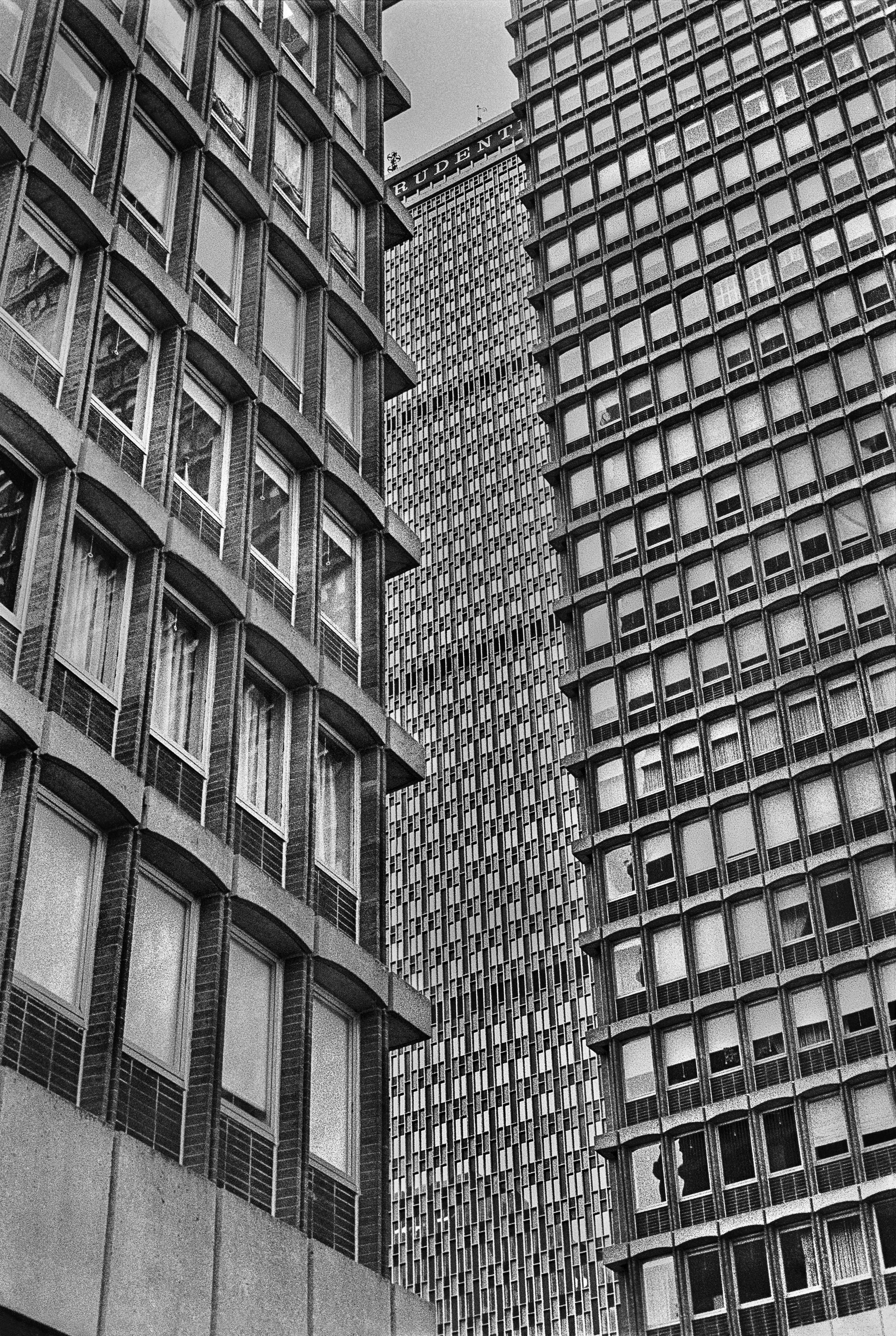 Monochrome view of downtown skyscrapers with geometric patterns and reflections.