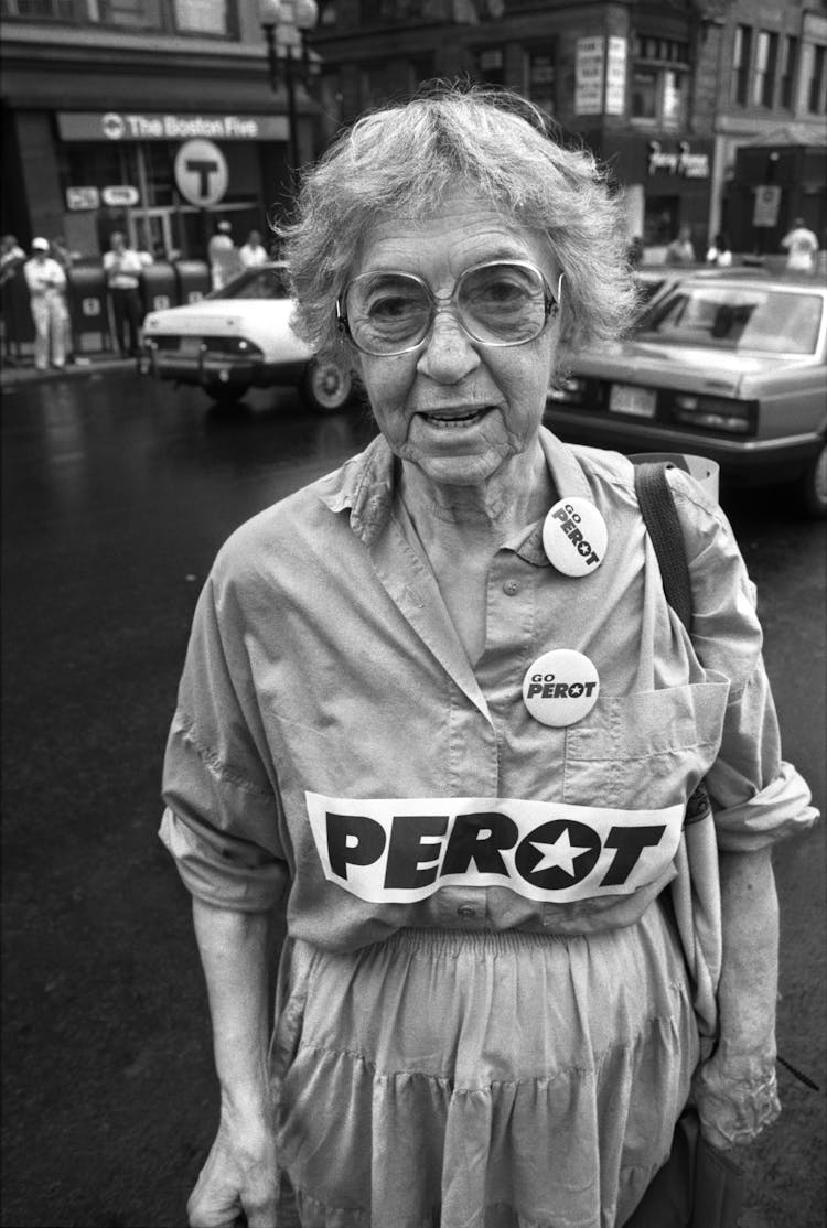 Elderly Woman Wearing Voting Pins During Election 