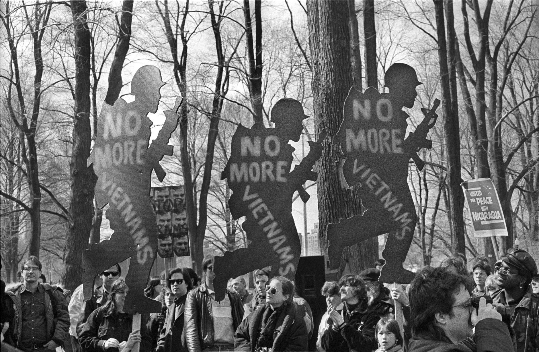 Black and white image of protest with signs against the Vietnam War.