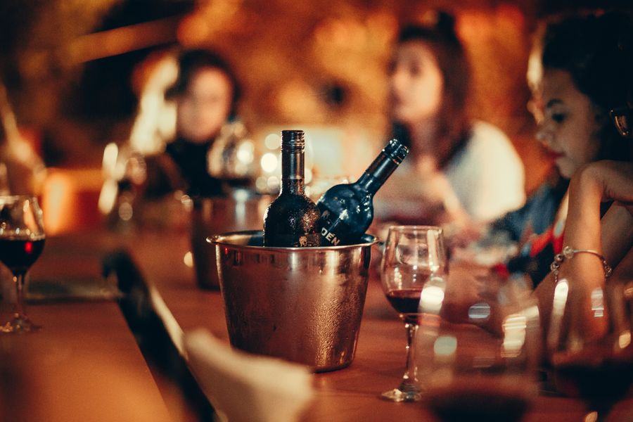 Wine bottles and glasses on a bar counter