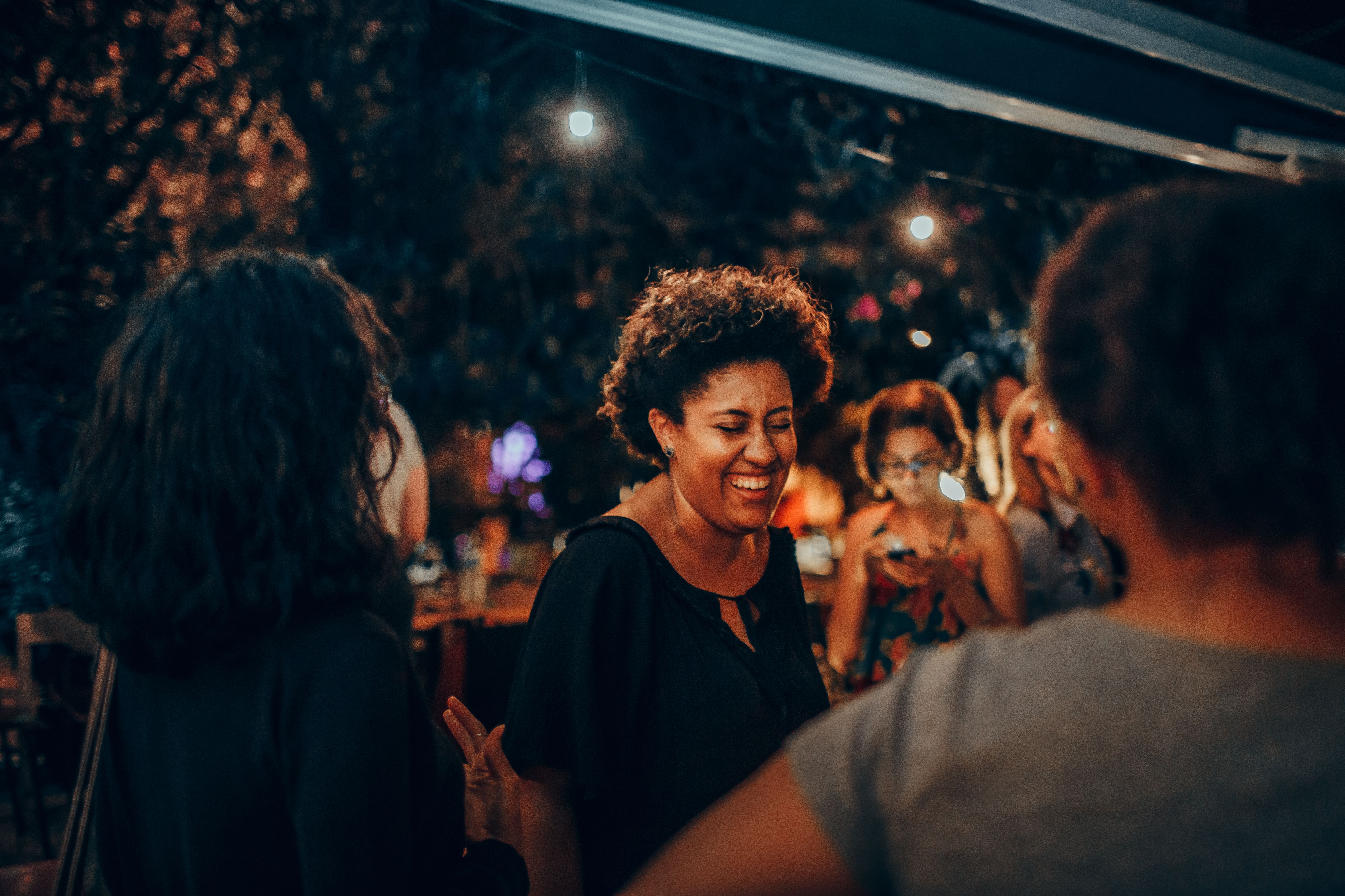 Evening fellowship gathering in Ho Ghana with warm lighting and people smiling