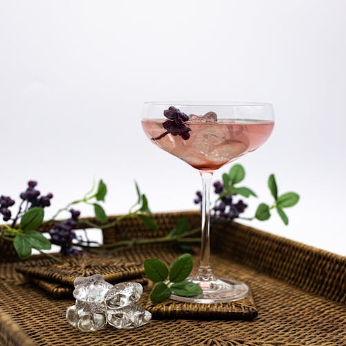 Close-up Photo of Wine Glass with Pink Drink 