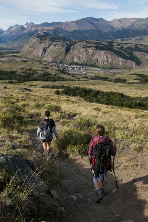 Free Two women hiking in a breathtaking mountainous landscape under a clear sky. Stock Photo