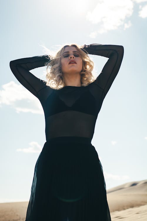 A Woman Wearing Black Dress while Posing