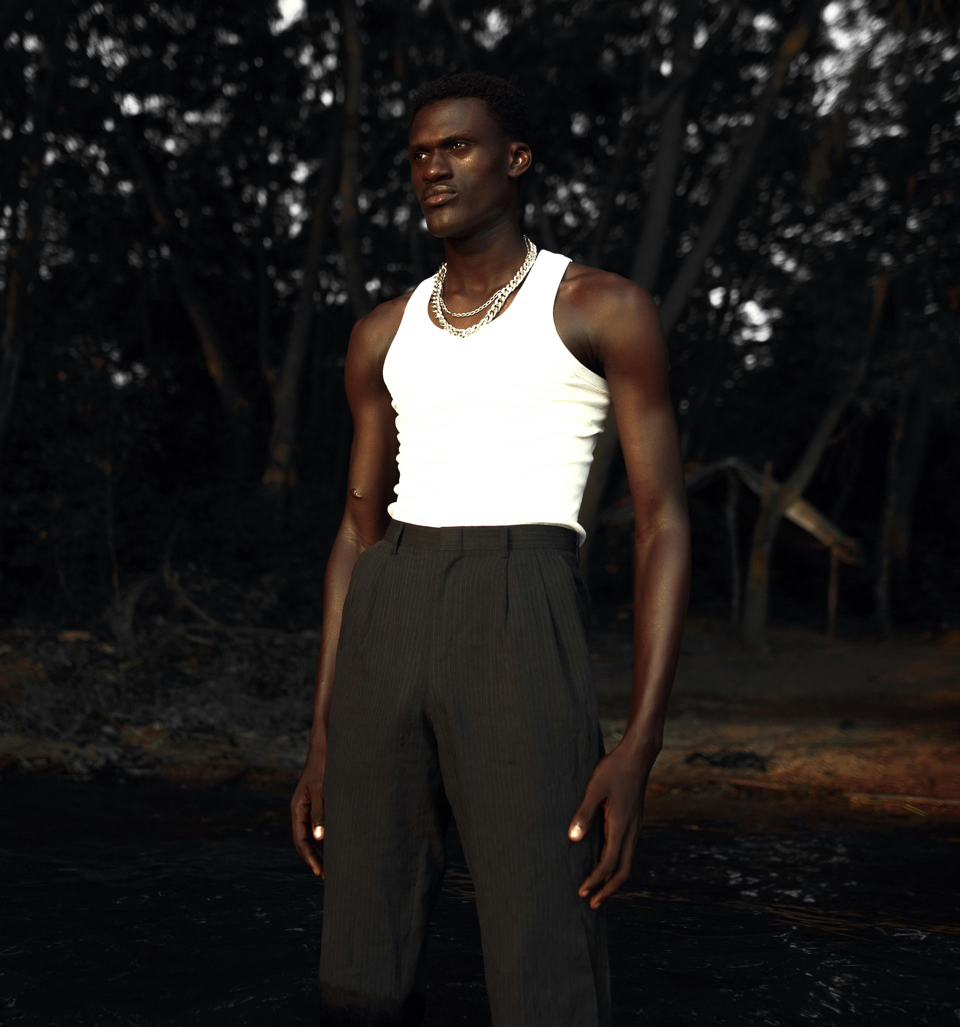 Young Athletic Man Posing in Black Tank Top and Pants · Free Stock