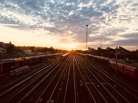 A stunning sunset view over railway tracks with trains lined up, capturing a moment of urban tranquility.