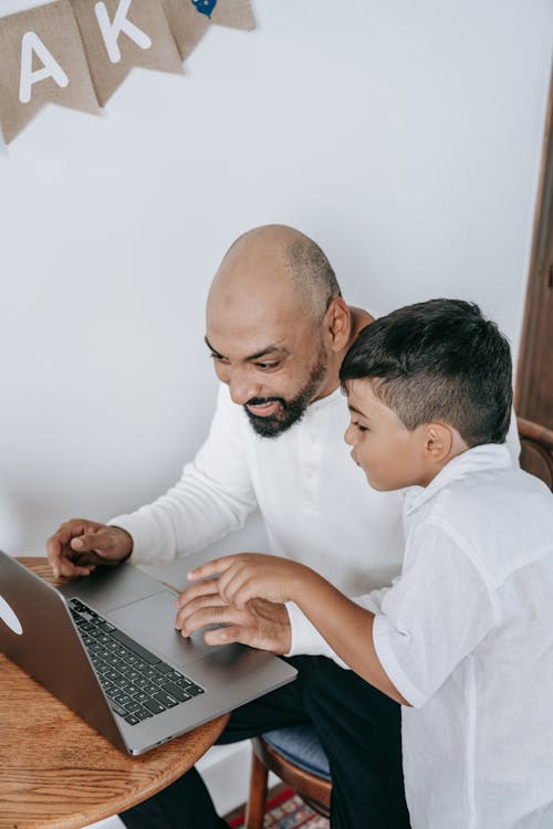 Father and Son using Laptop 