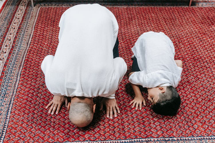 Father And Child Praying On The Floor