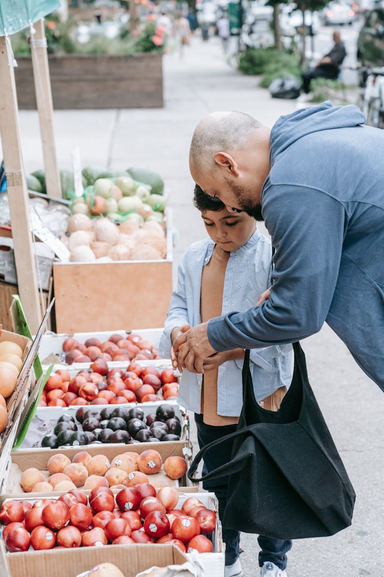 Father And Son Shopping At The Market