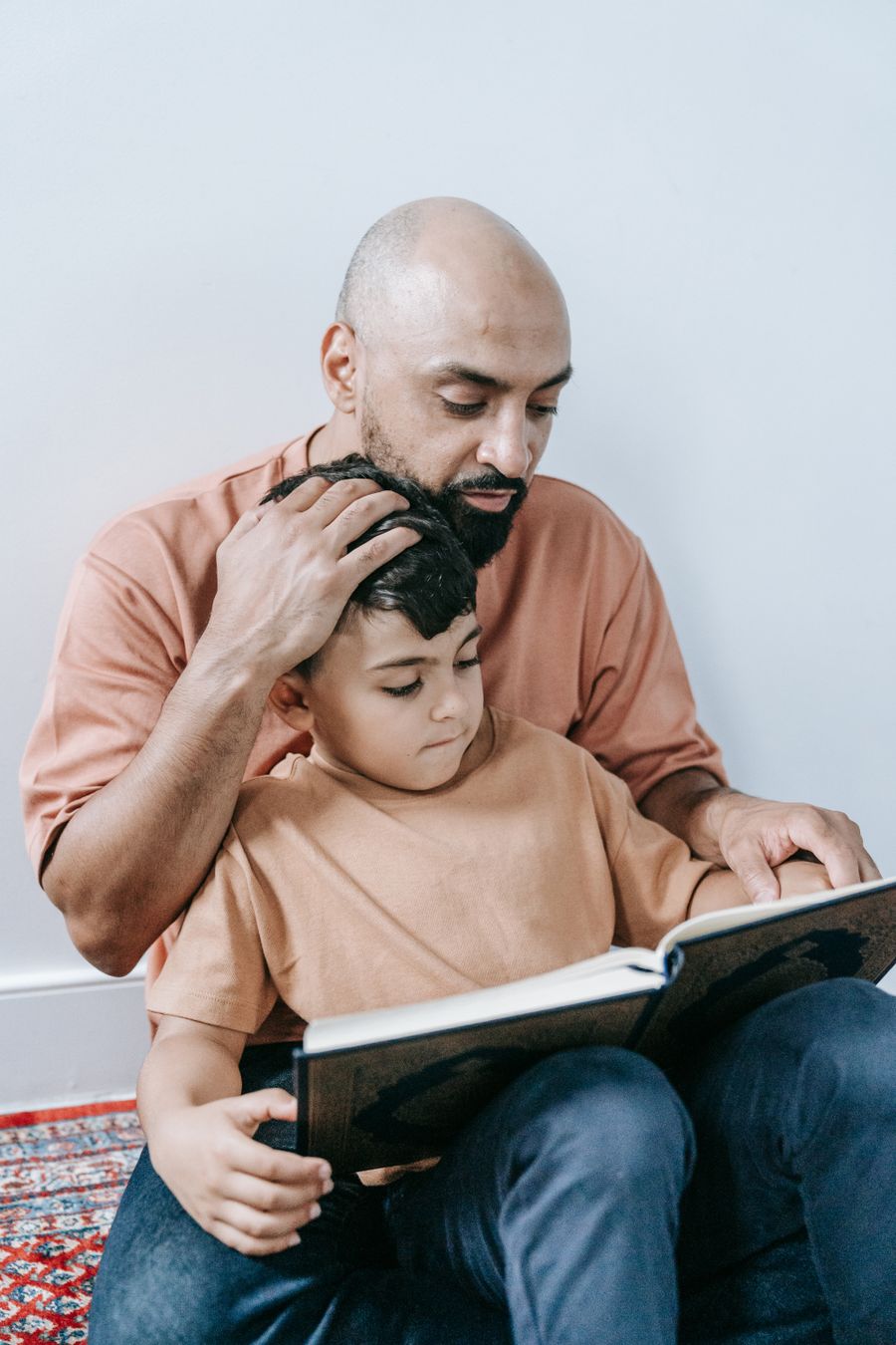 A father reading with his school-age son
