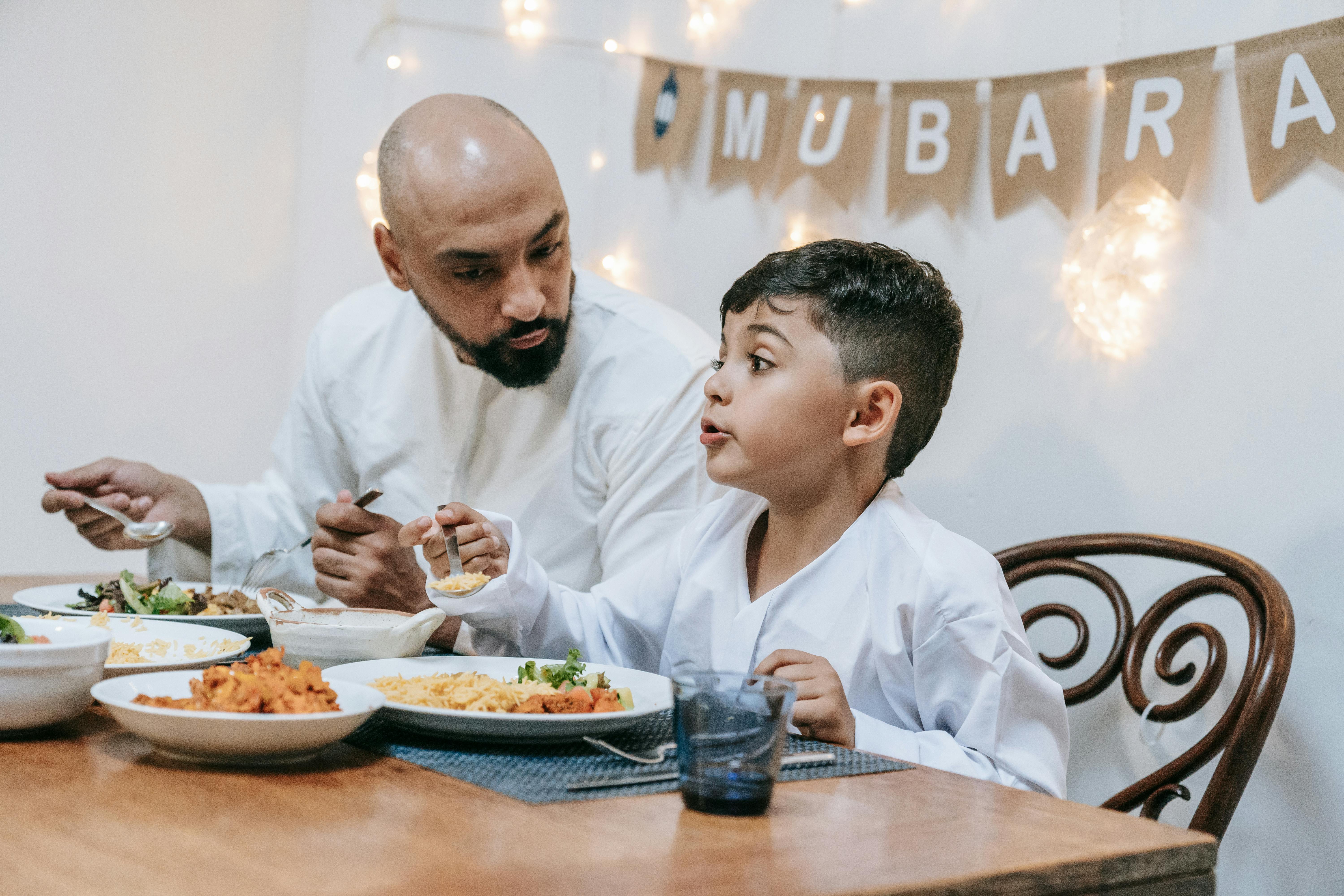 a man eating with his son