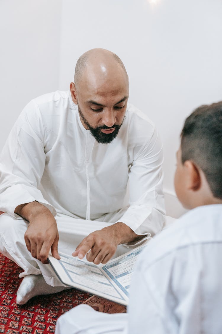 Father Reading Koran To Son 