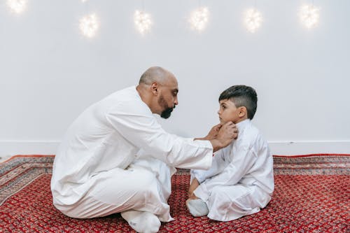 Free Father and Son Sitting Together on the Floor  Stock Photo