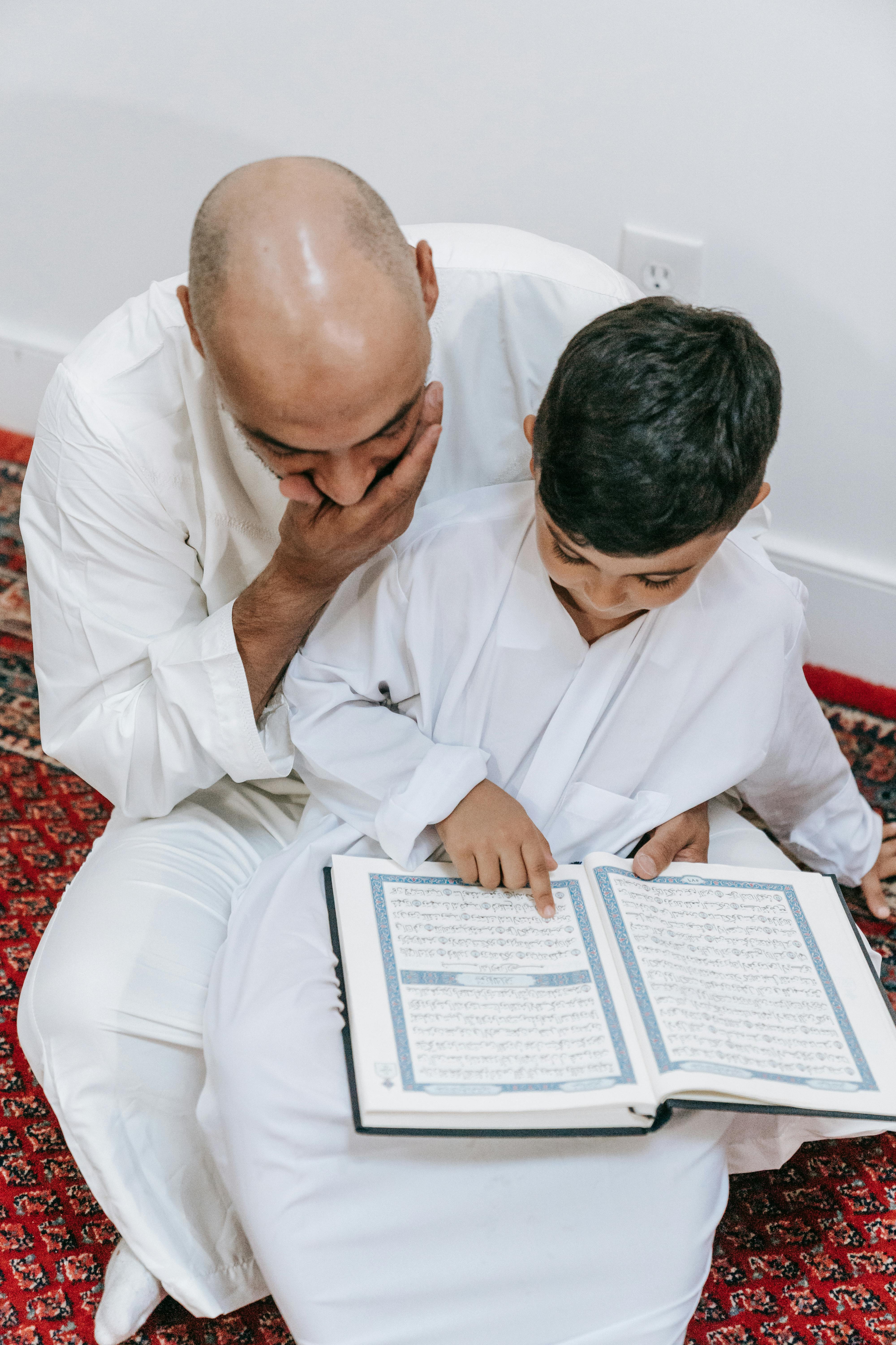 man in white dress shirt reading book