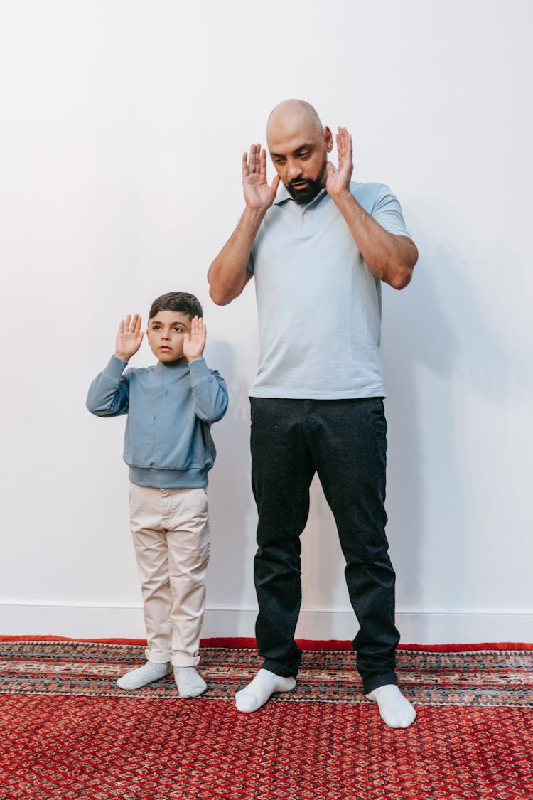 Father And Son Raising Their Arms