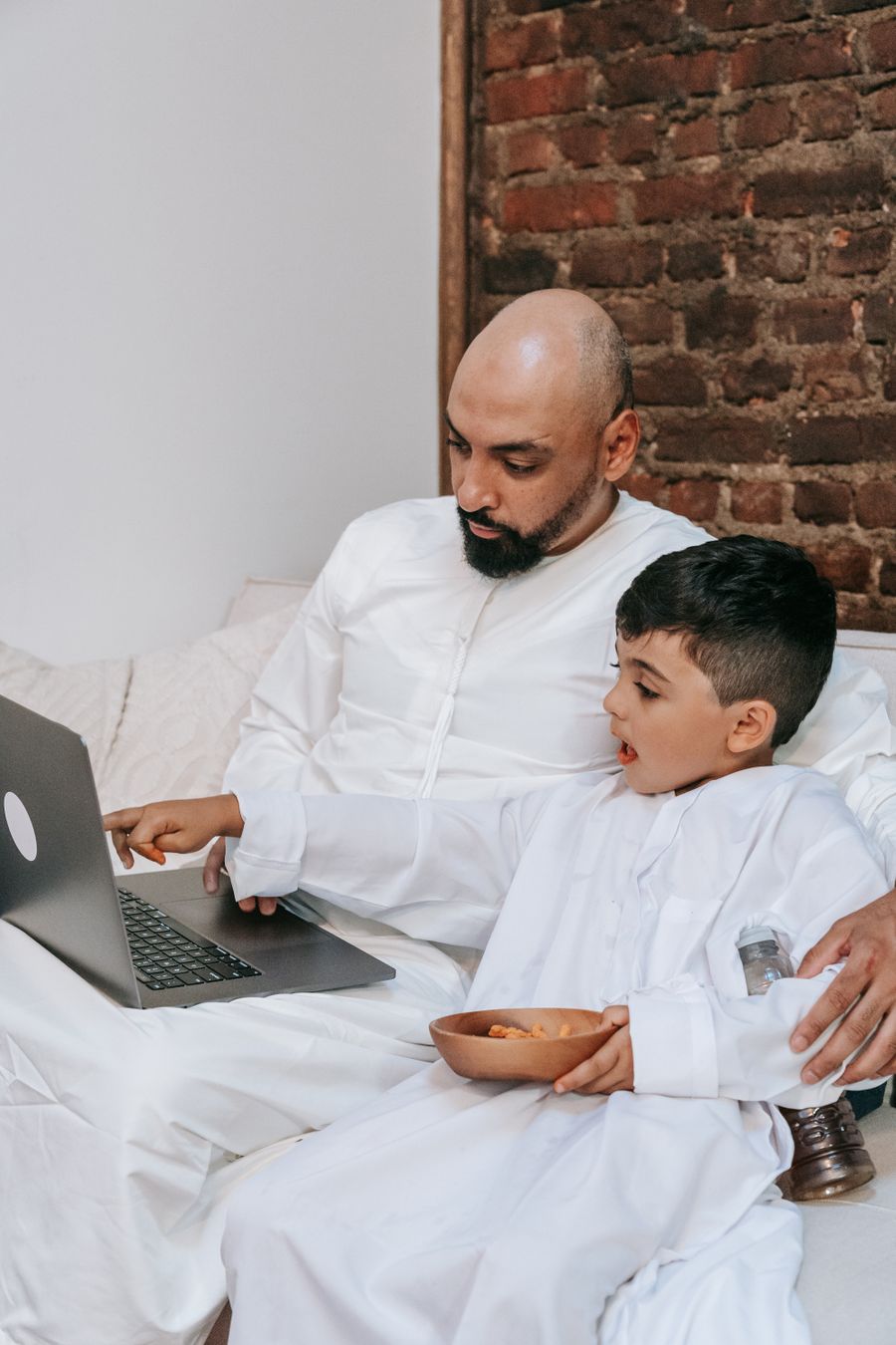 Parent and child looking through a workbook together