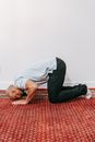 A Man Kneeling on the Floor
