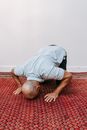 Man in White Shirt Lying on Red and White Rug