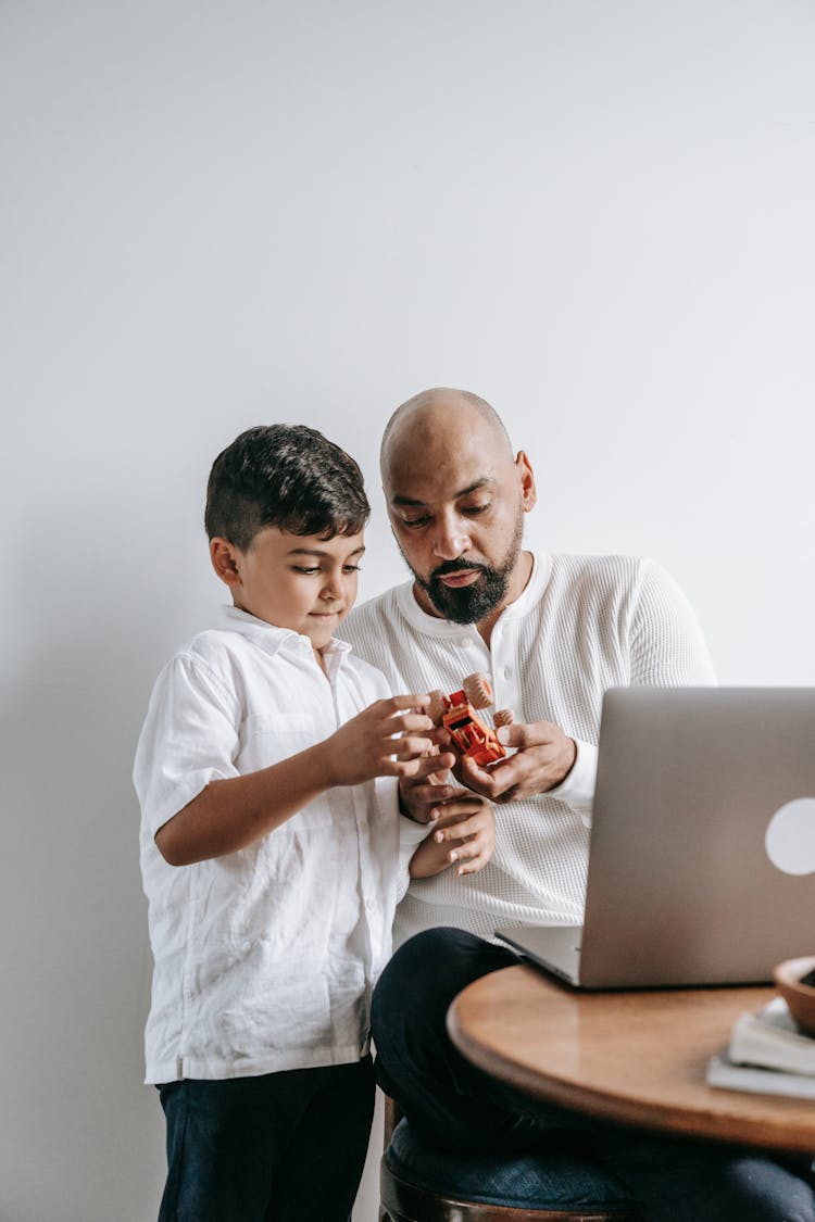 Father And Son Playing In The Room