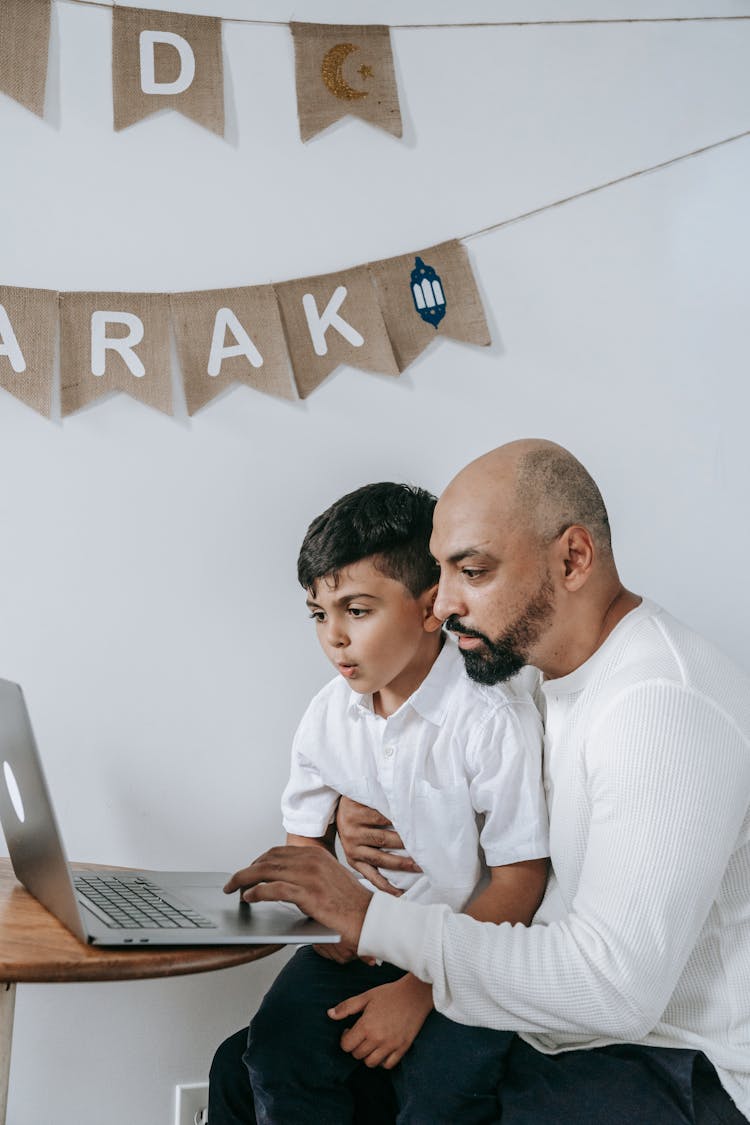 Father And Son Working On Laptop