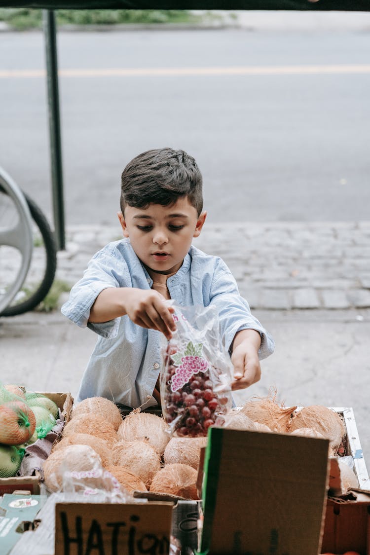 A Boy At A Market Stall