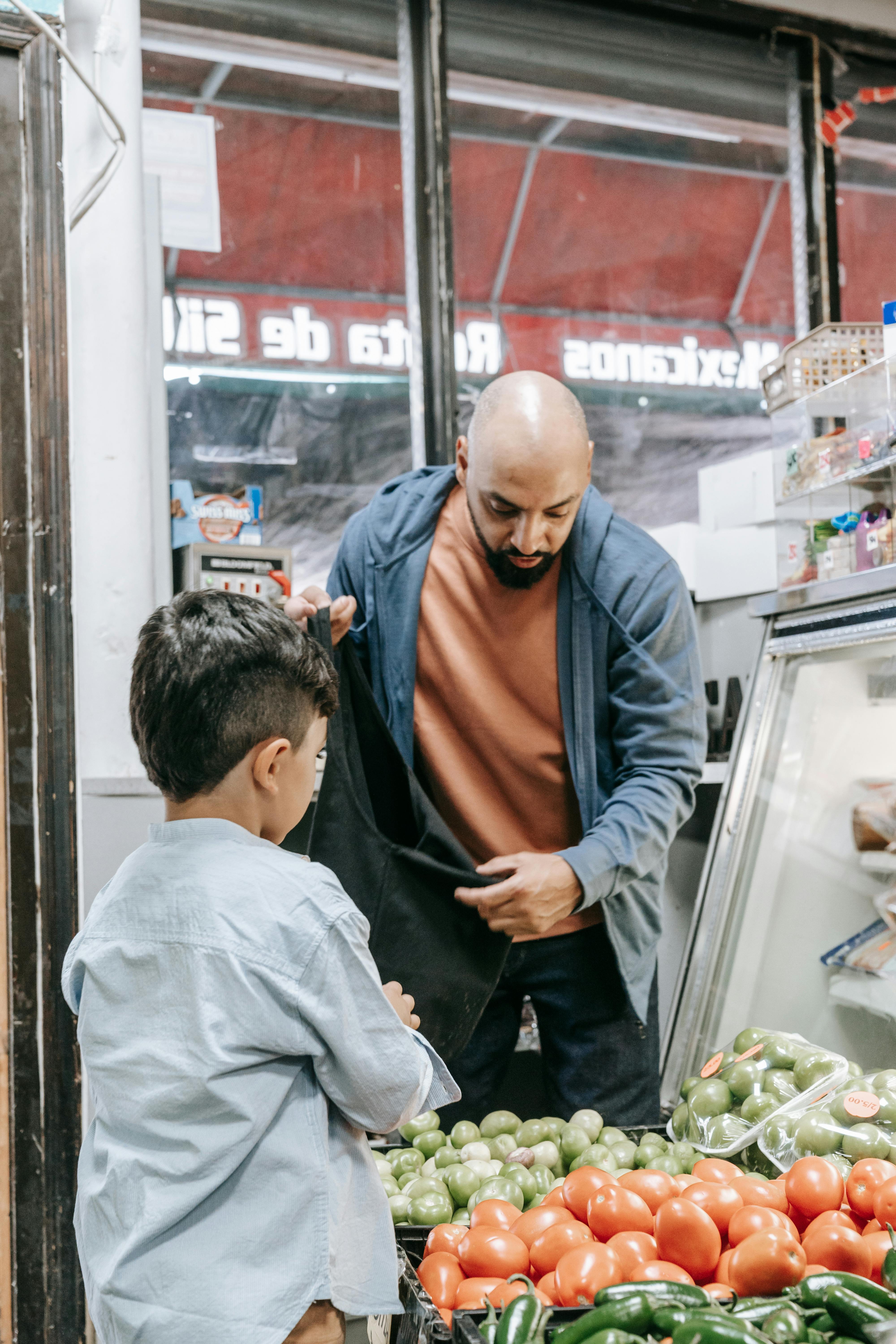 a man and a boy buying fruits