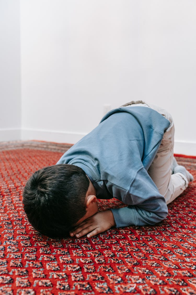 Boy Praying On Floor