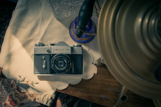 Top view of a classic Zenit-B film camera on a vintage wooden table.