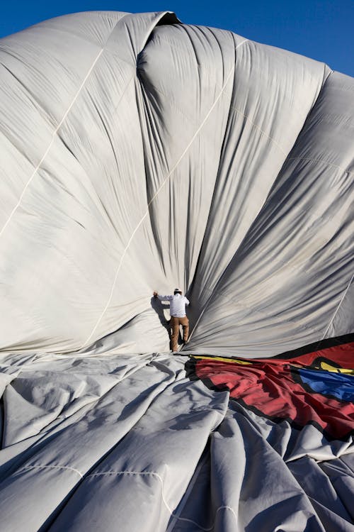 bezplatná Základová fotografie zdarma na téma deflated, horkovzdušný balón, muž Základová fotografie