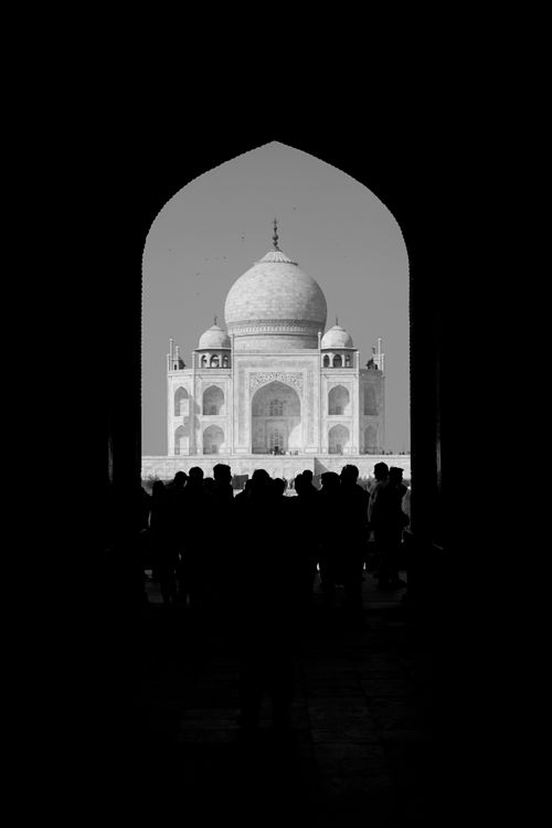 Free Black and white silhouette view of the Taj Mahal through an arched doorway. Stock Photo