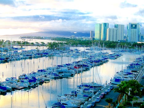 Photo by 10 Star Picturesque harbor with yachts and city skyline in Honolulu, Hawaii during daytime.