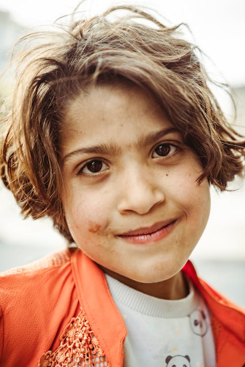 Free Portrait of a Cute Girl in Orange Jacket Stock Photo