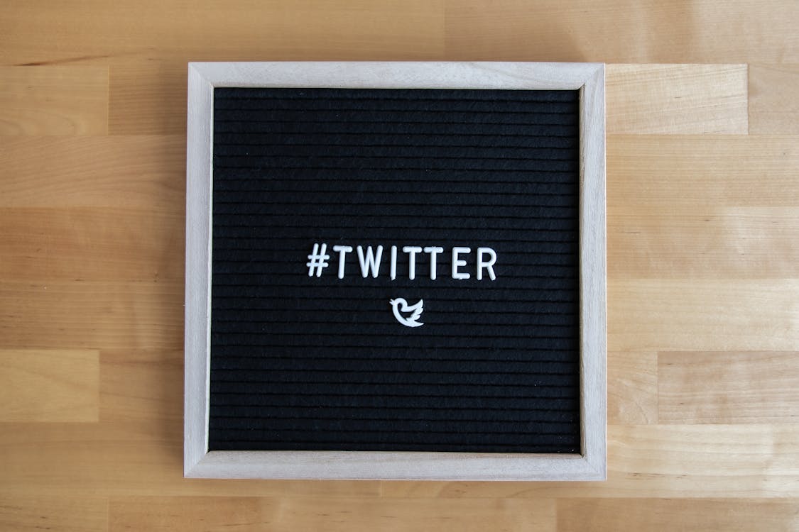 A black and white board that says #Twitter with a bird below it. 